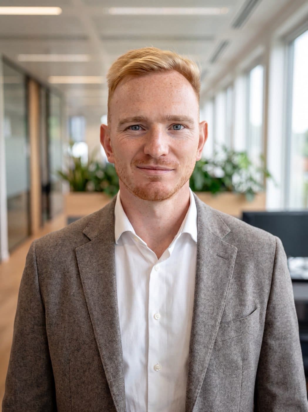 Sergey Girshev, founder and CEO of Fleetera, in a grey jacket and white shirt in an office
